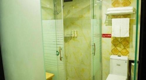 a bathroom with a glass shower and a toilet at GreenTree Alliance Ningbo Cixi Guanghaiwei Industrial Park East Area Hotel in Ningbo