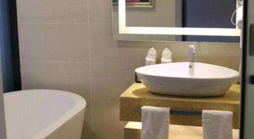 a bathroom with a sink and a toilet at Lavande Hotel Yichang Railway East Station Branch in Yichang