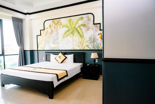 a bedroom with a bed with a painting on the wall at Khách sạn Đại An Ninh Bình in Ninh Binh