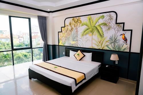 a bedroom with a bed with a painting on the wall at Khách sạn Đại An Ninh Bình in Ninh Binh
