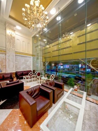 a lobby with leather furniture and a chandelier at Samdi Premium - Near Da Nang International Airport in Da Nang