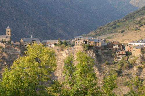 a group of houses on the side of a mountain at Casa Rural La Comella in Tirvia