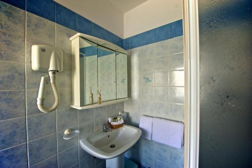 a bathroom with a sink and a mirror at Hotel La Bussola in Muggia