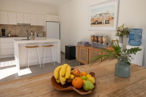 a bowl of fruit on a table in a kitchen at Aloha Byron Bay in Byron Bay