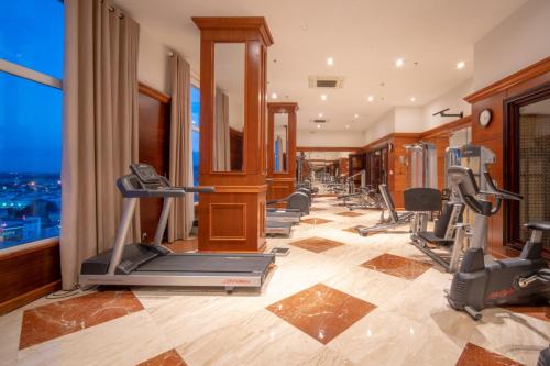 a gym with cardio equipment in a hotel room at Samdi Premium - Near Da Nang International Airport in Da Nang