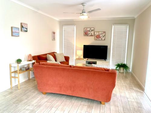 a living room with a couch and a flat screen tv at River Retreat in American River