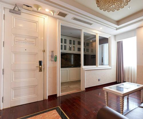 a living room with a door and a table at Samdi Premium - Near Da Nang International Airport in Da Nang