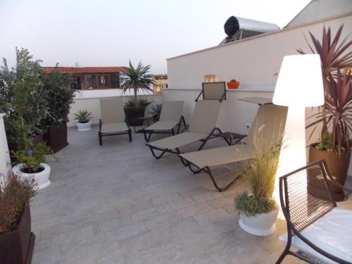 a patio with chairs and plants on a roof at RIAD Comfort Rooms in San Vito lo Capo