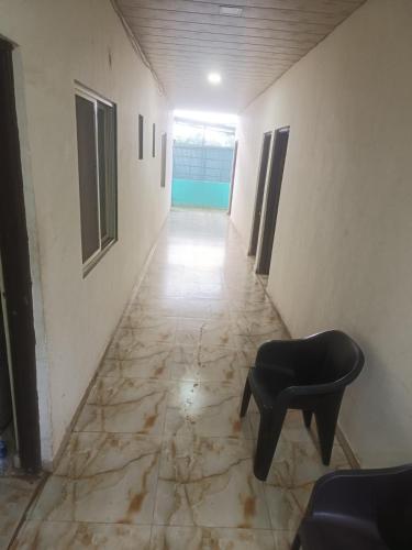 an empty hallway with a chair and a room at Samadhan Lodge in Vangani