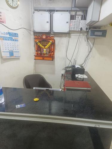 a desk in a room with a table and a chair at Samadhan Lodge in Vangani