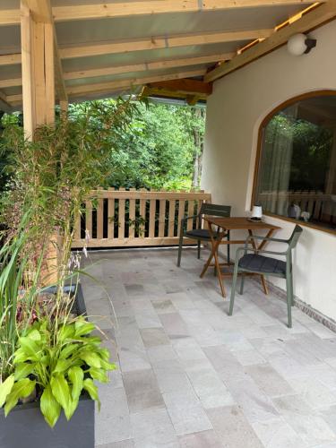 a patio with a table and chairs on a porch at Rezi Pava in Pava