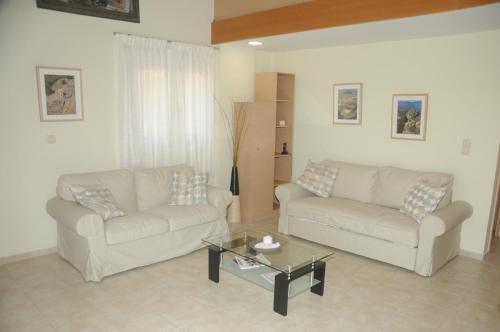 a living room with two couches and a coffee table at Aegean View Villa in Loutraki