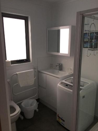 a small bathroom with a sink and a toilet at Scout Hall in National Park
