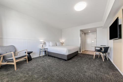 a hotel room with a bed and a tv at The Leea Resort Darwin in Darwin