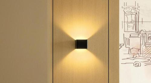 a light on the side of a wooden door at City Comfort Inn Liuzhou Liucheng in Liuzhou