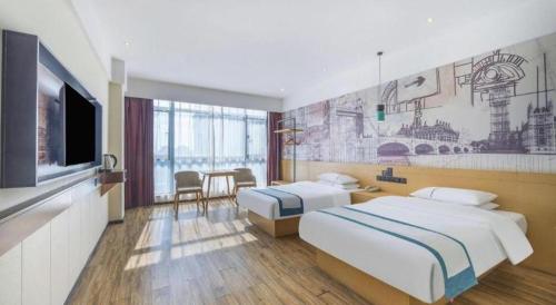 a hotel room with two beds and a television at City Comfort Inn Changsha South Railyway Station West Square in Changsha