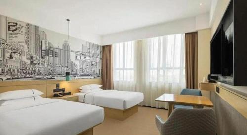 a hotel room with two beds and a tv at City Comfort Inn Lijiang Ancient Town in Lijiang