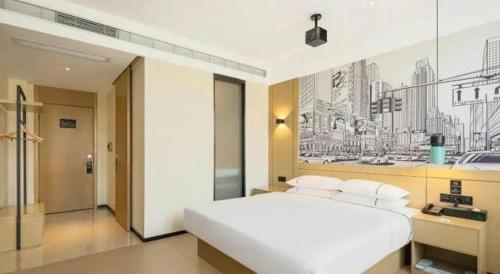 a bedroom with a white bed and a painting on the wall at City Comfort Inn Lijiang Ancient Town in Lijiang