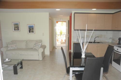 a kitchen and living room with a couch and a table at Aegean View Villa in Loutraki