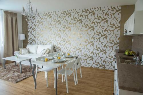a living room with a white table and a couch at Villa Grande - Apartmány in Olomouc