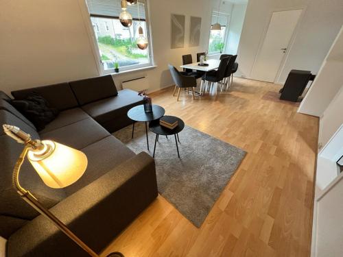 a living room with a couch and a table at Central trainstation apartment in Narvik