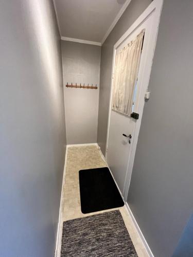 a small room with a door and a window at Central trainstation apartment in Narvik