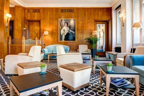 a lobby with couches and tables at Hotel Eden in Geneva