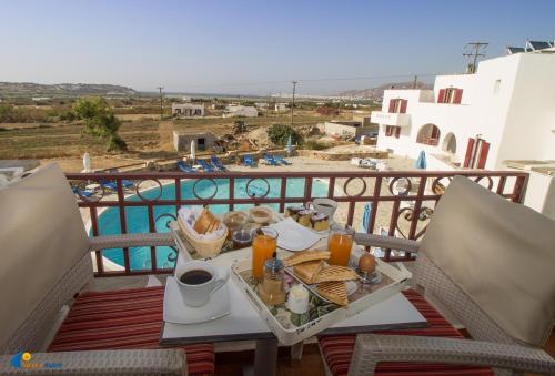a tray of food on a table on a balcony at Naxos Mare in Agia Anna Naxos