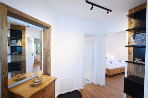 a room with a mirror and a bed in a room at ChiemseeGlück in Chieming