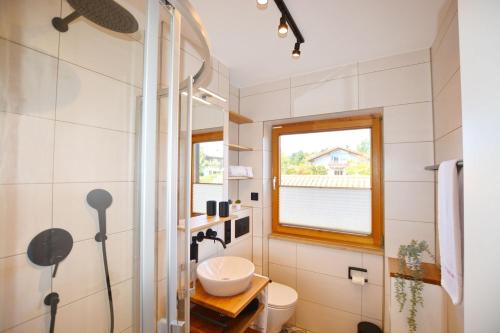 a bathroom with a sink and a window at ChiemseeGlück in Chieming