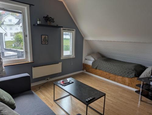 a living room with a bed and a coffee table at Railway central loft apartment in Narvik