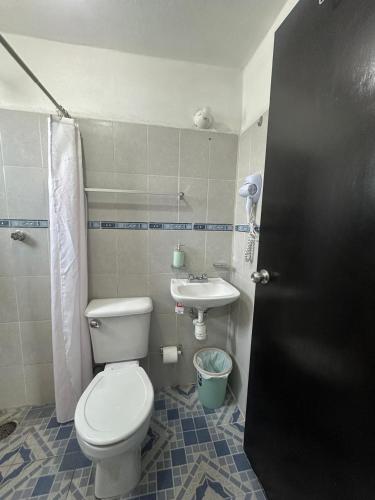 a bathroom with a toilet and a sink at Don Tuga in Oaxaca City