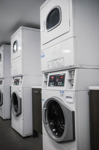 a group of washing machines and dryers in a room at Studio 8 Residences - Adults Only in Sydney