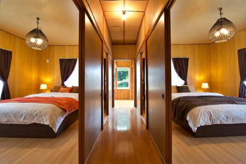 En eller flere senge i et værelse på Resort Villa N&N