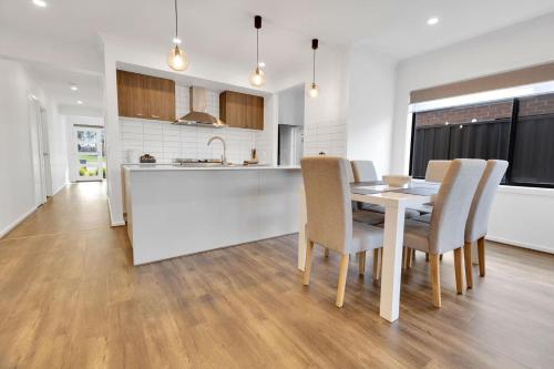 a kitchen and dining room with a table and chairs at Ravish in Paynesville