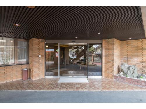 an entrance to a brick building with glass doors at Hotel WWJ - Vacation STAY 82120v in Ina