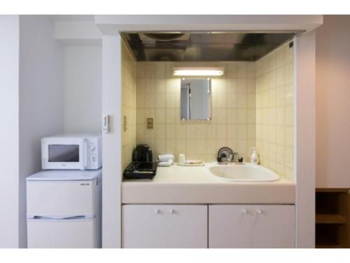 a kitchen with a sink and a microwave at Hotel WWJ - Vacation STAY 82120v in Ina