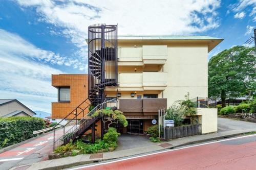a building with a spiral staircase in front of it at Hotel WWJ - Vacation STAY 82100v in Ina