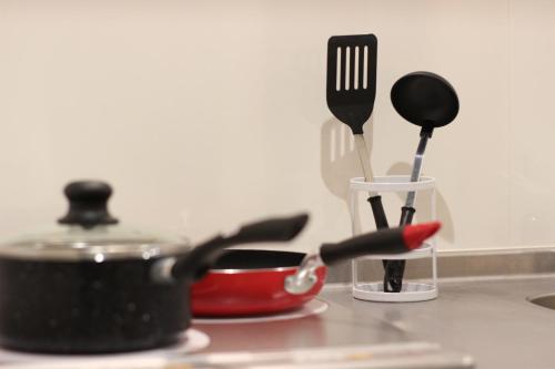 a kitchen counter with utensils and a pot and spatula at Rest Collection Jingu Nijo Kyoto in Kyoto