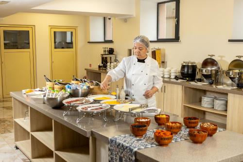 a woman standing in a kitchen preparing food at INFINITY PLAZA BLOCK 1 in Atyraū