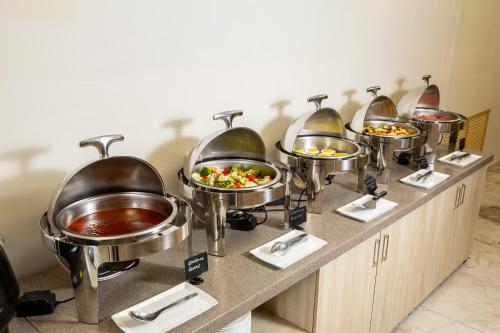 a buffet line with bowls and plates of food at INFINITY PLAZA BLOCK 1 in Atyraū