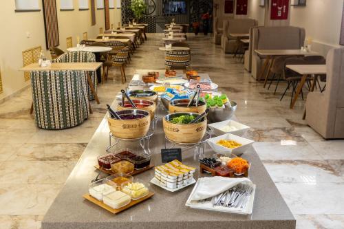 a buffet of food on a table in a restaurant at INFINITY PLAZA BLOCK 1 in Atyraū