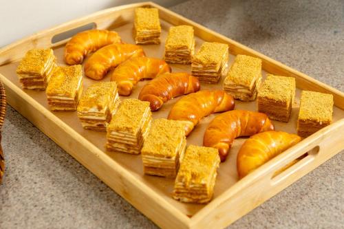 a tray of bread and pastries on a table at INFINITY PLAZA BLOCK 1 in Atyraū