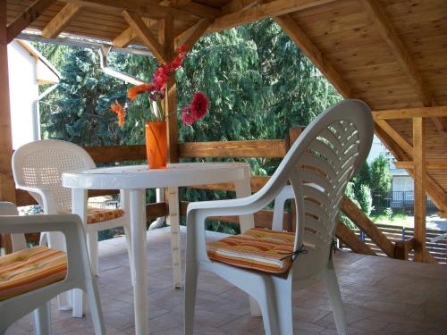 a white table and chairs on a patio at Éden II. in Miskolctapolca