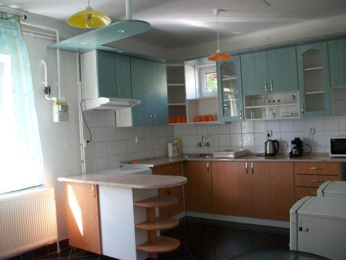 a kitchen with blue cabinets and a counter top at Éden II. in Miskolctapolca