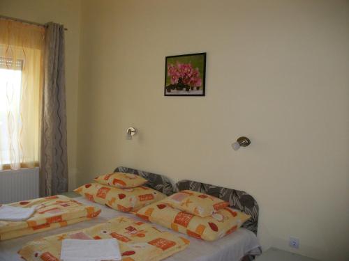 a bedroom with a bed and a picture on the wall at Éden II. in Miskolctapolca