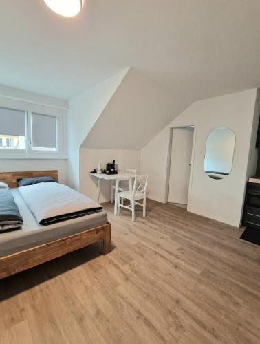 a bedroom with a bed and a table in it at Casa Maria Bern in Bern