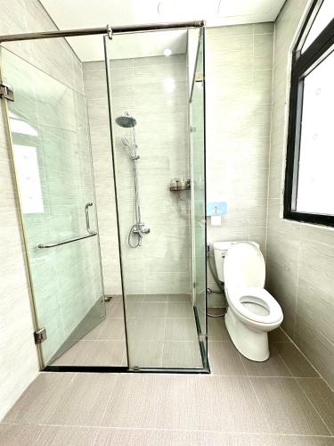 a bathroom with a shower and a toilet at Moc Lam Homestay GrandWorld Phu Quoc in Phu Quoc