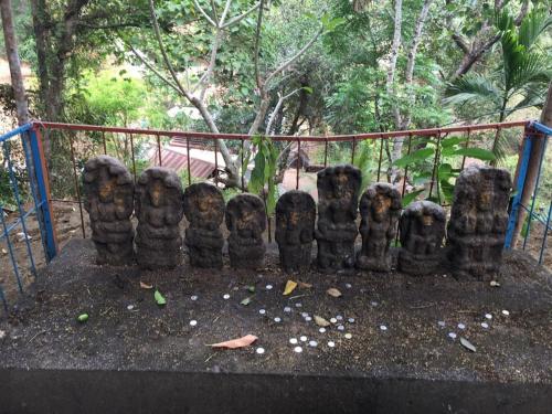 a group of statues sitting on the ground at Ganesha Homestay in Malayāttūr