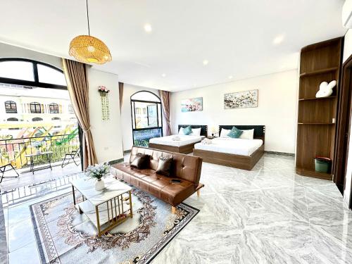 a living room with a couch and a bed at Moc Lam Homestay GrandWorld Phu Quoc in Phu Quoc